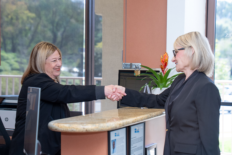 Staff member shaking hand with patient